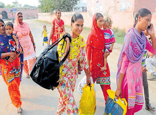 OFF TO A SAFER PLACE: Villagers along the border near Attari migrate after the government asked people to vacate their homes falling in the 10-km range of the International Border on Thursday. PTI