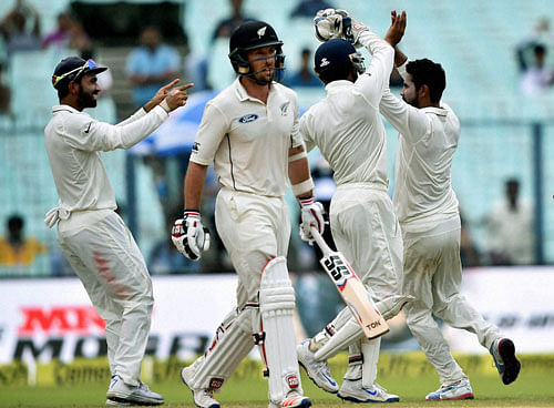 Ravindra Jadeja celebrates with teammates after the dismissal of New Zealand batsman Luke Ronchi during 2nd Test Match in Kolkata on Saturday. PTI Photo