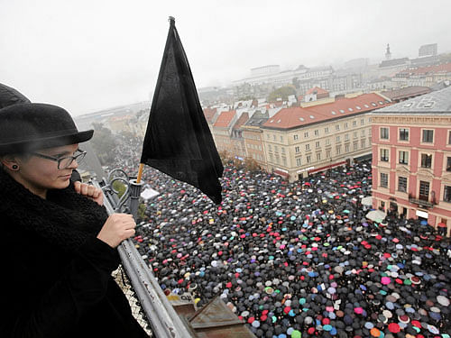 A woman observes thousands of people during an abortion rights campaigners' demonstration to protest against plans for a total ban on abortion in front of the Royal Castle in Warsaw. Reuters Photo