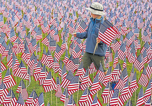 dashed hopes: A boy walks among some of the 3,000 flags placed in memory of the lives lost in the September 11, 2001 attacks, at a park in Illinois, US. The US support for Jasta, or the Justice Against Sponsors of Terrorism Act has unsettled the US-Saudi ties. reuters