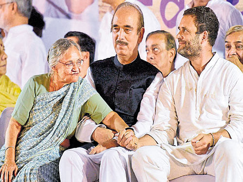 Congress vice-president Rahul Gandhi with party's chief ministerial face in UP, Sheila Dixit, and senior leader Ghulam Nabi Azad at a rally in Jantar Mantar in New Delhi on Thursday. PTI