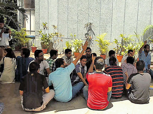 Research students stage a sit-in against the new directive on attendance register at the  Institute for Social and Economic Change at Nagarabhavi on Thursday. dh photo