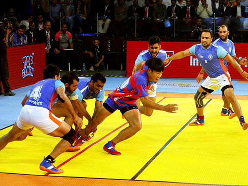 Indian players try to catch South Korean player Tae Beom Kim during their inaugural match of the Kabaddi World Cup-2016 in Ahmedabad on Friday. PTI Photo