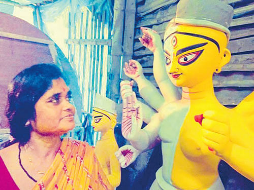 China Pal works on an Durga idol at Kumortuli.