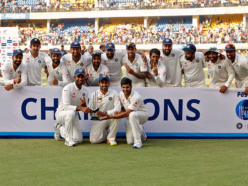 India's players pose with the trophy after winning the test series. REUTERS