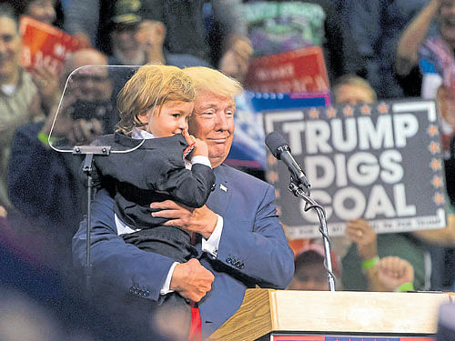 Donald Trumpholds a young boy dressed as himduring a rally in Pennsylvania. Trump's battle with hisown party has been tearing open the country's politicalmap, pulling Republicans across the country into a self-destructive feud. NYT