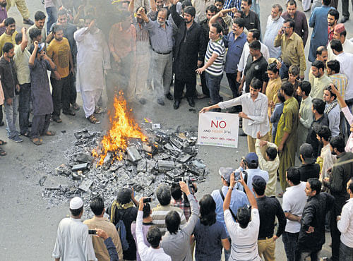 SELLING CONFLICT: Pakistani shopkeepers and traders burn Indian products including TV transmission systems and CDs during ademonstration in Lahore. Peace doesn'tmake good TV. Dialogue is not an exciting visual. The history of Kashmir doesn't fit into 140 characters