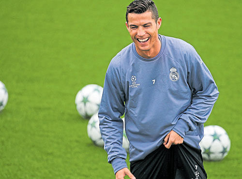 THAT WAS A GOOD ONE: Real Madrid's Cristiano Ronaldo enjoys a light moment during a training session on Monday. REUTERS