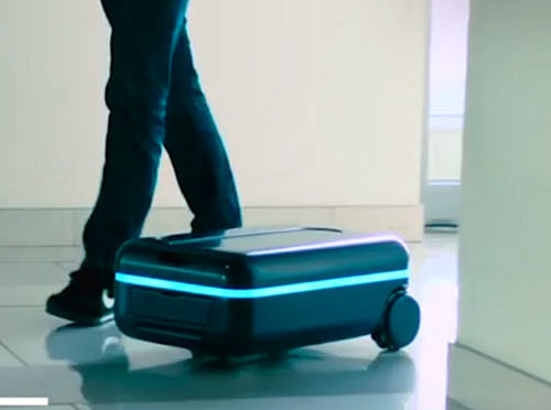 The suitcase, called Travelmate, stays three to five feet behind the owner by tracking the location of their smartphone. It moves either upright, or while laying on its side. Screen Grab