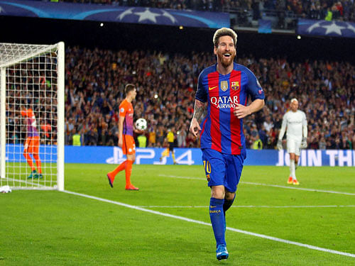 Barcelona's Lionel Messi celebrates after scoring his side's third goal during a Champions League, Group C soccer match between Barcelona and Manchester City, at the Camp Nou stadium in Barcelona. AP/PTI