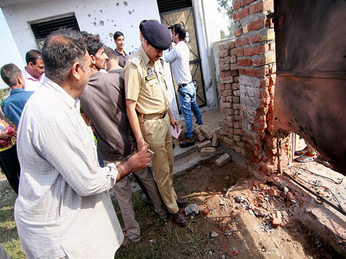 Jammu & Kashmir DSP inspecting the damage caused by shelling from across the LoC in Vidipur Jatta village of RS Pura sector, about 27km from Jammu,on Saturday. PTI Photo