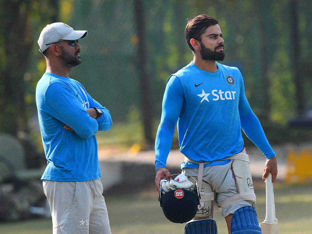 Team India skipper MS Dhoni and Vice Captain Virat Kohli during a team practice session on the eve of 3rd ODI against New Zealand at the PCA Stadium in Mohali on Saturday. PTI Photo