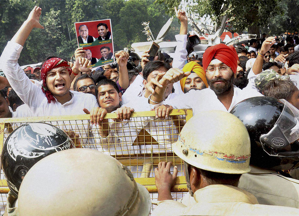 Uttar Pradesh Chief Minister Akhilesh Yadav's supporters raise slogans at the Samajwadi Party office in Lucknow on Monday. PTI