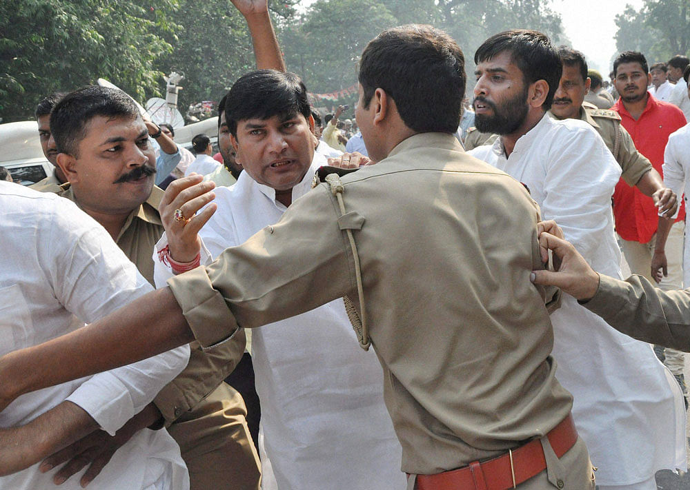 Police intervenes after supporters of UP Chief Minister Akhilesh Yadav and UP SP President Shivpal Singh Yadav clash near the party office in Lucknow on Monday where both the leaders were attending a crucial meeting with senior party leaders. PTI Photo