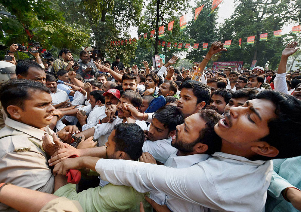 Police try to control the supporters of Uttar Pradesh Chief Minister Akhilesh Yadav, who shouted slogans outside the Samajwadi Party office in Lucknow on Tuesday. PTI