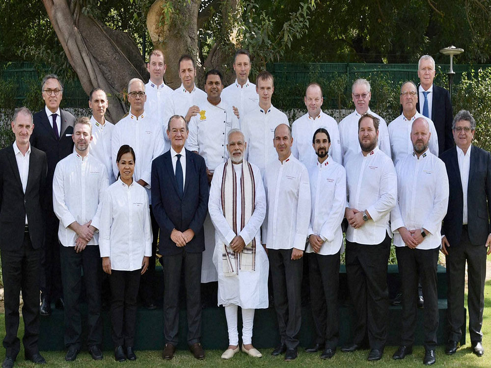 Members of the Club des Chefs des Chefs (Club of Presidential Chefs from across the Globe) pose for a group photo with Prime Minister Narendra Modi in New Delhi on Tuesday. PTI Photo