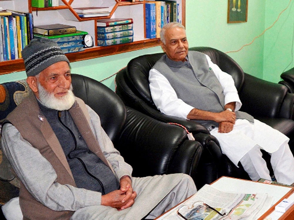 Former Union minister and Senior BJP leader Yashwant Sinha with Chairman of Hurriyat Conference Syed Ali Shah Geelani at a meeting at his residence in Srinagar on Tuesday. A five-member delegation headed by Sinha arrived in valley to meet Separatists, mainstream leaders and other people regarding the current crisis in Kashmir. PTI Photo