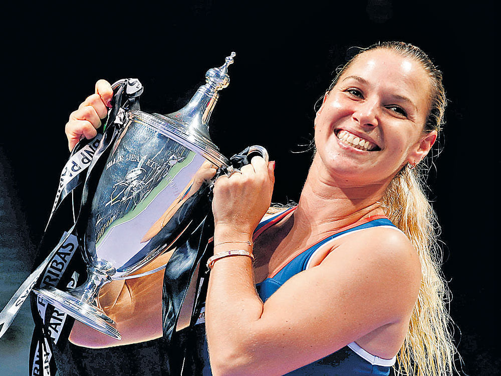 Dominika Cibulkova of Slovakia is thrilled with her prize after defeating Angelique Kerber of Germany in the WTA Tour Finals in Singapore on Sunday. Reuters