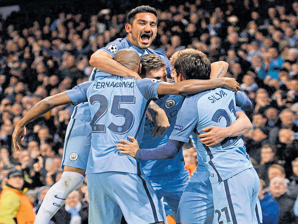 Manchester City players celebrate a goal against Barcelona during their Champions League tie at the Etihad Stadium on  Tuesday. Reuters
