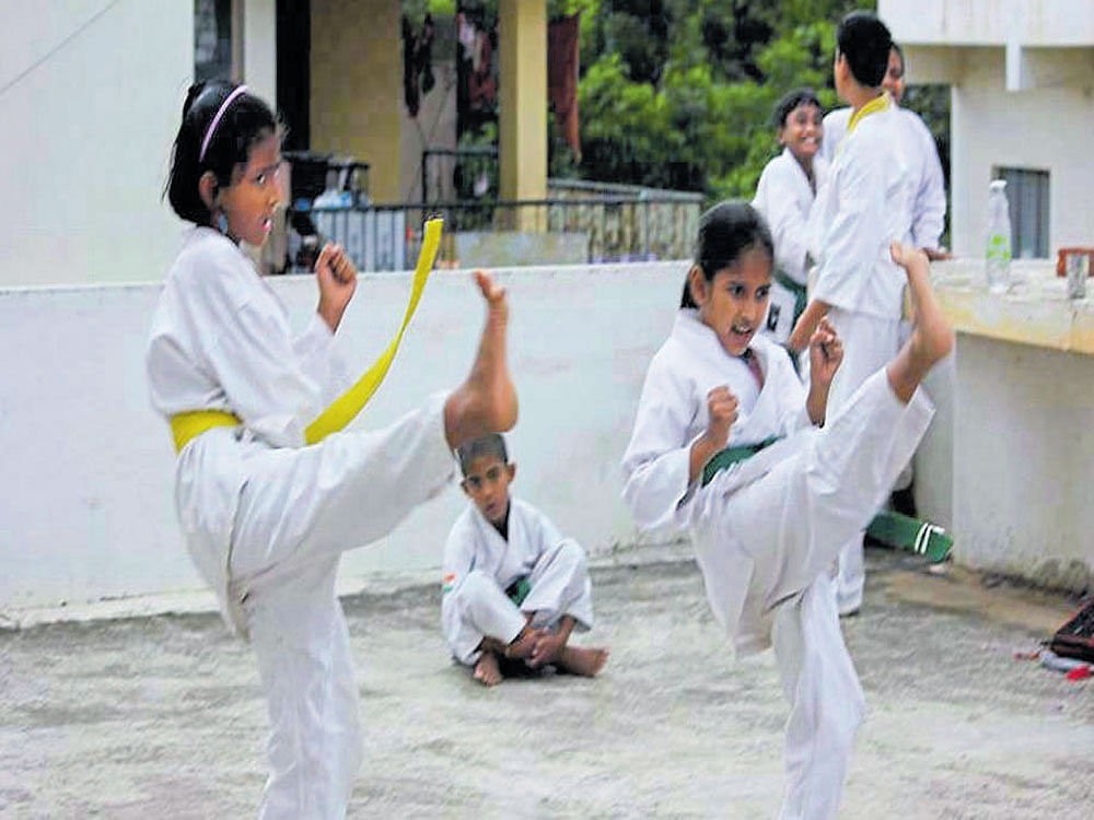 Children undergo martial arts training.