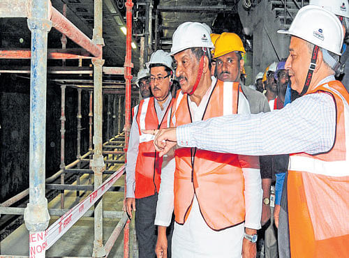 Bengaluru Development Minister K J George, BMRCL MD Pradeep Singh Kharola and other officials inspect the progress of work on the Namma Metro underground stretch at Majestic Metro Station on Friday. DH PHOTO