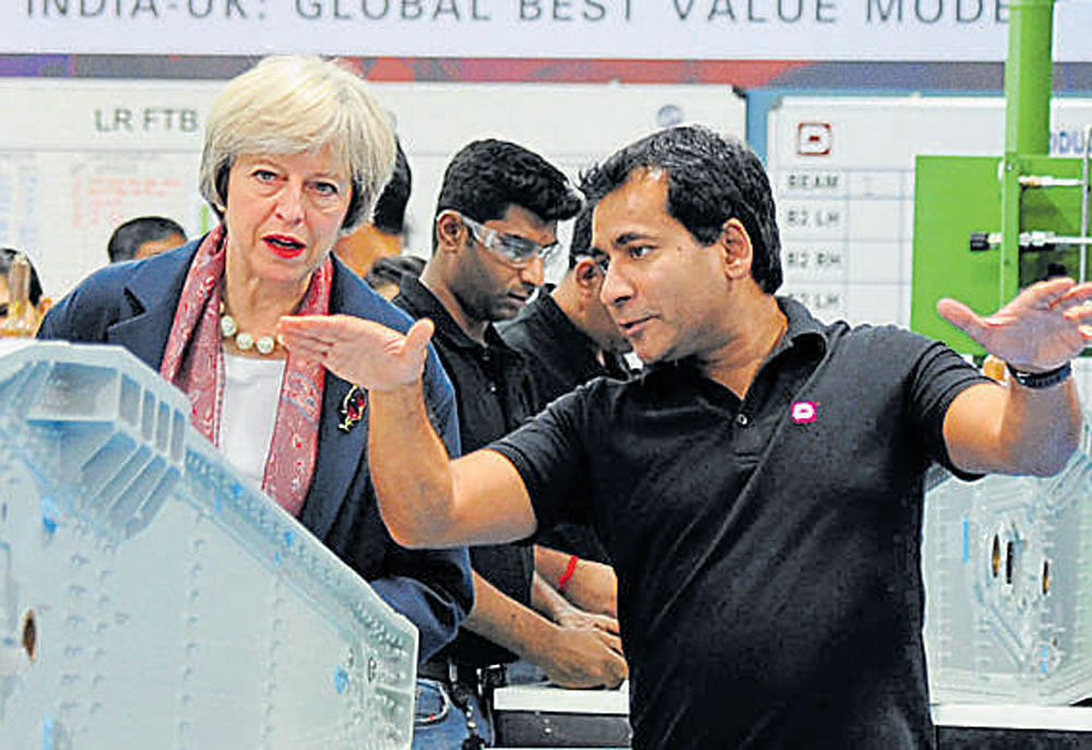 British Prime Minister Theresa May interacts with Dynamatic CEO Udayant Malhoutra in Bengaluru on Tuesday.