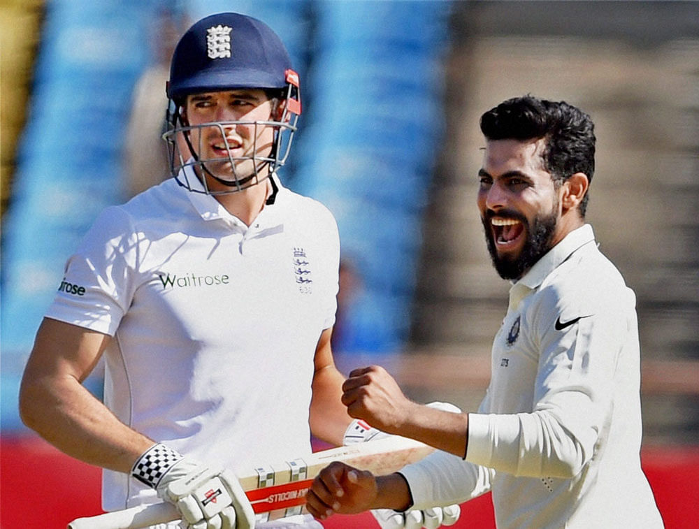 India's Ravindra Jadeja celebrates the wicket of England batsman Alastair Cook during day 1 of the first test match in Rajkot on Wednesday. PTI Photo