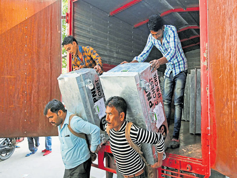 Workers unload boxes containing money outside a bank in Chandigarh on Tuesday REUTERS