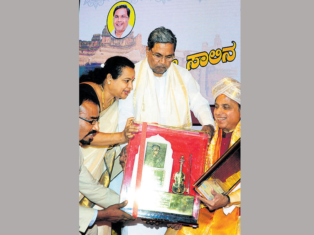 Chief Minister Siddaramaiah presents T&#8200;Chowdiah Award to percussionist Suresh  Talwalkar on Tuesday.
