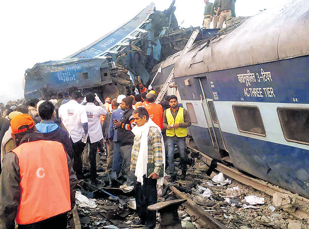 Rescue workers search for survivors in the wreckage of the train. PTI