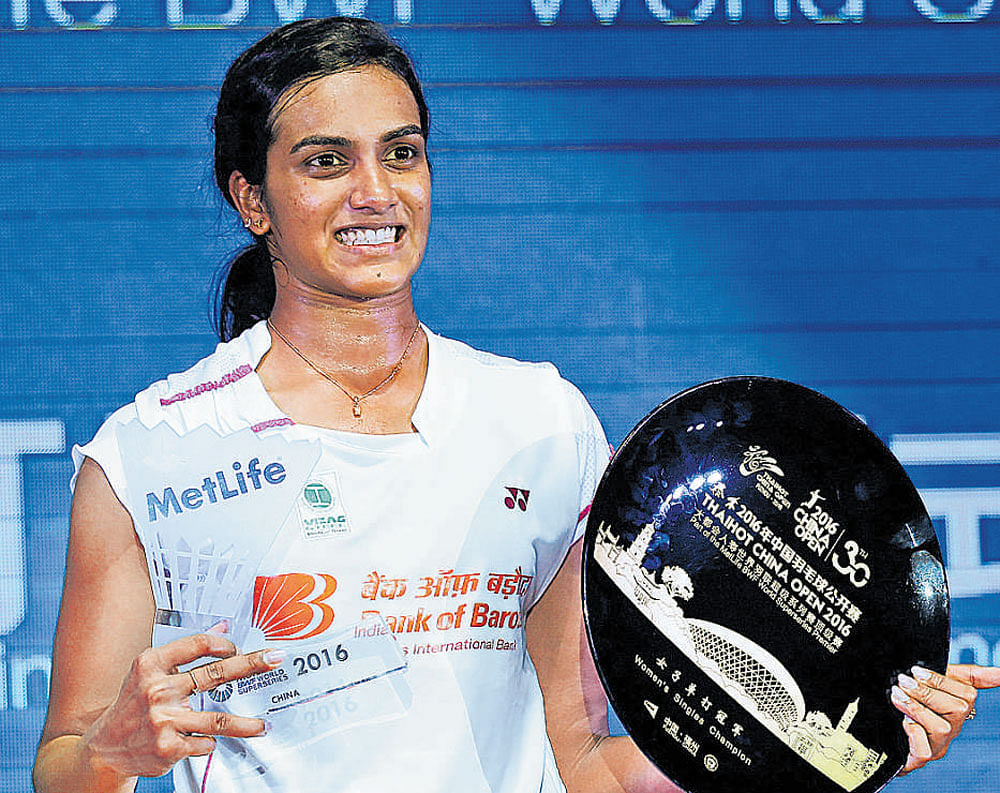 P V Sindhu with her trophy after she beat China's Sun Yu in the final of the China Open Badminton tournament in Fuzhou on Sunday. AFP