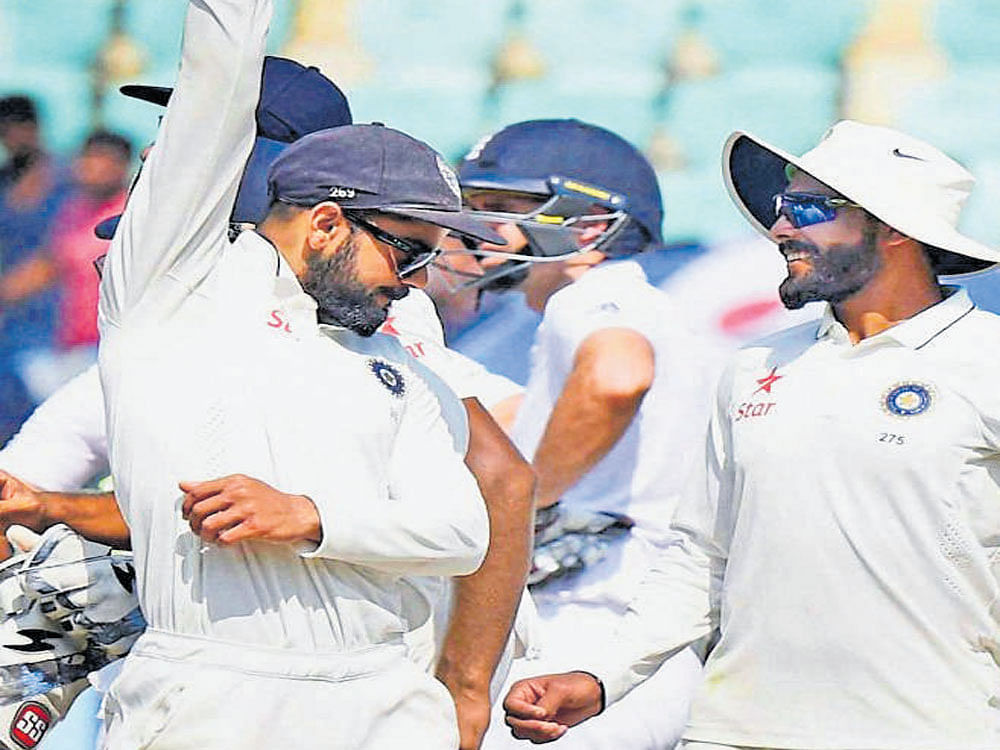 MISSION ACCOMPLISHED Virat Kohli (left) celebrates as the final England wicket falls at Visakhapatnam. PTI