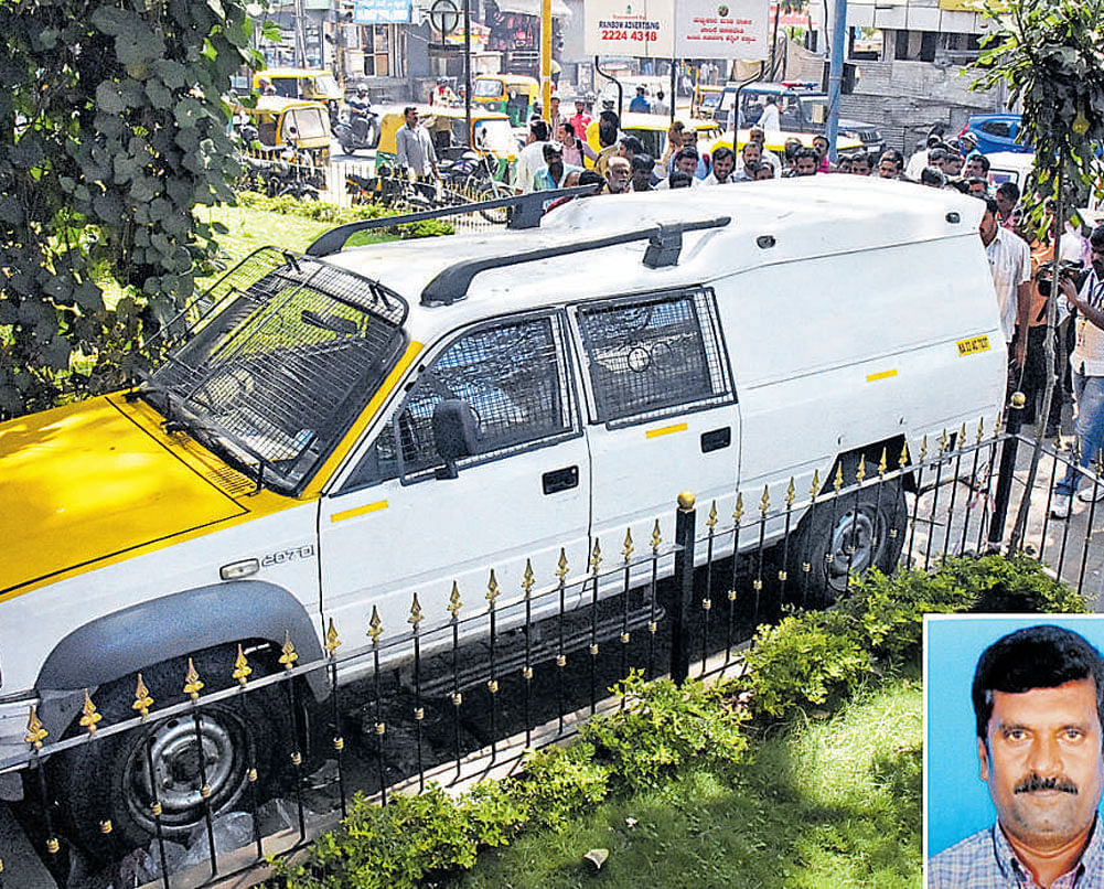 The ATM van, which was seized by the police on Thursday,  after driver Domnic (inset) fled with Rs 1.37 crore on Wednesday. DH Photo/ B K Janardhan