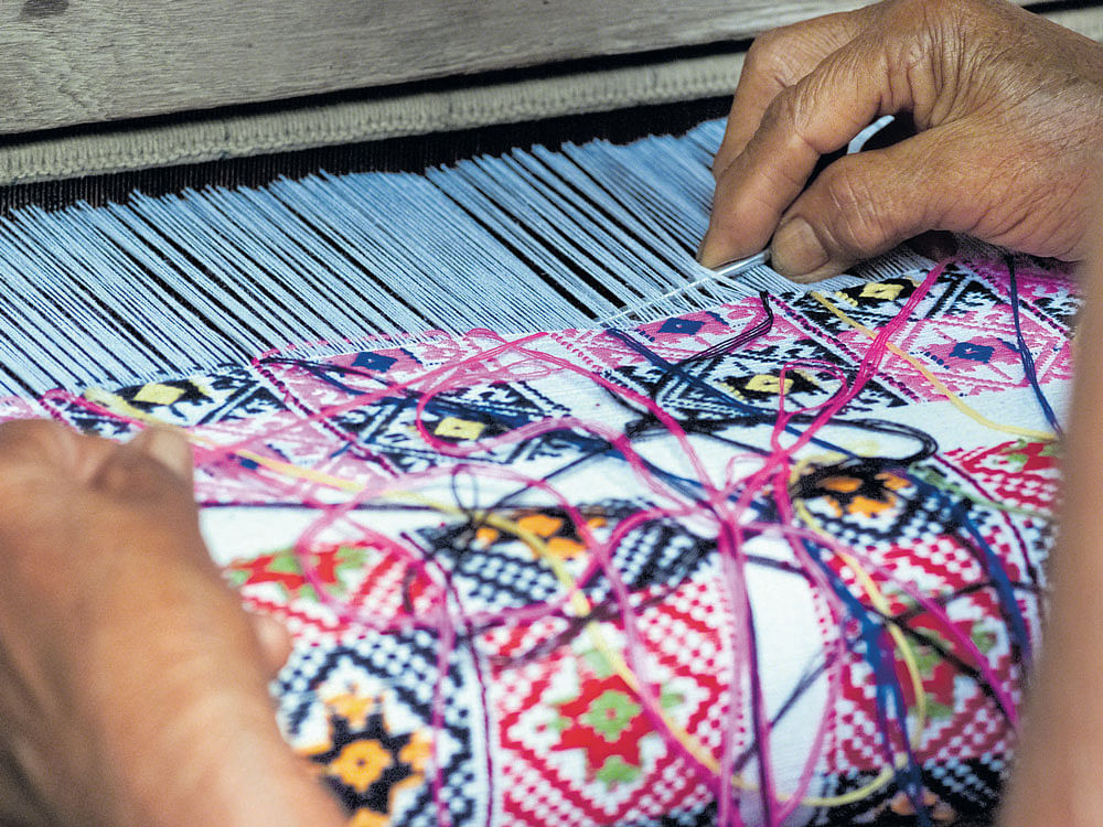 intricate A tribal woman working with the loom