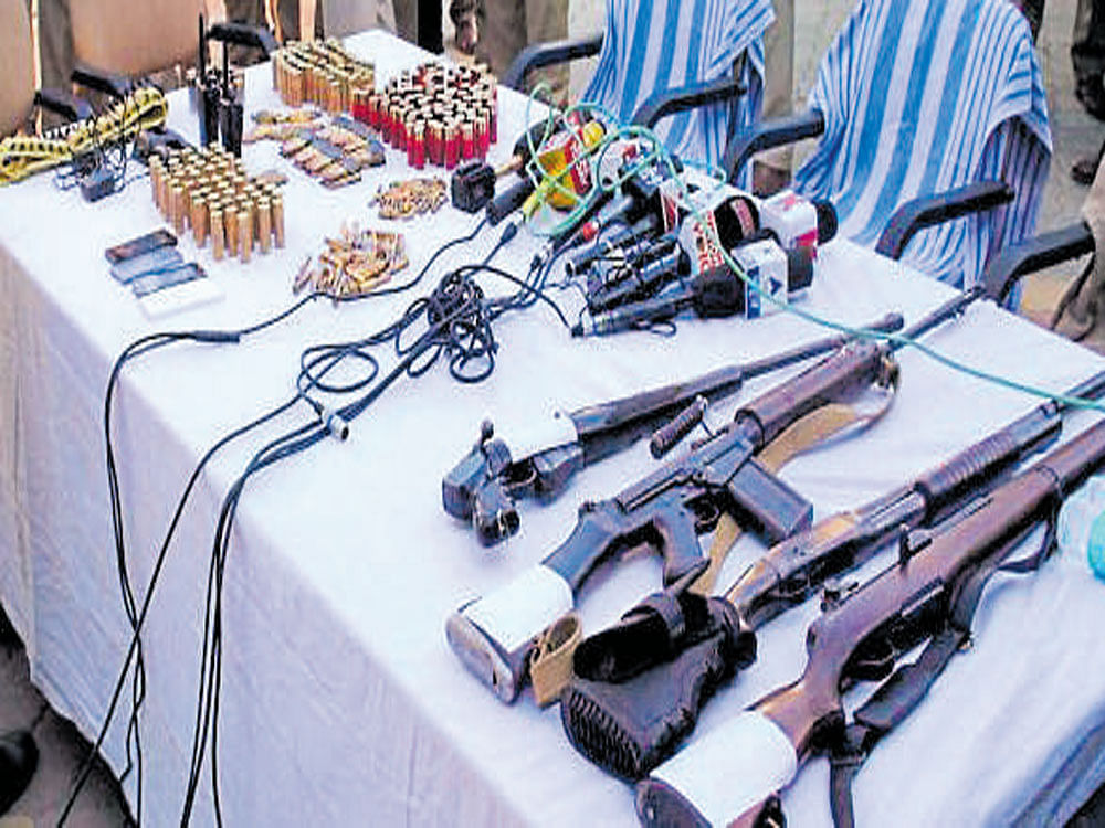 Police display the cache of arms recovered after the arrest of Parminder Singh, one of the Nabha jail attackers, in Shamli district of Uttar Pradesh on Sunday. PTI