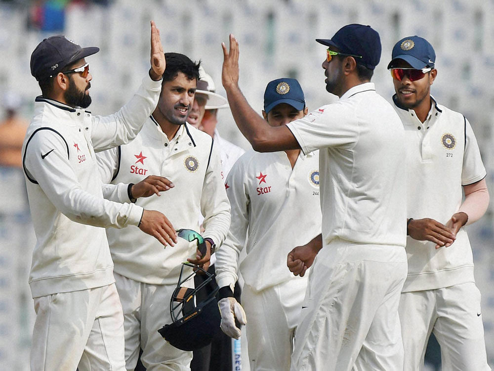 Indian players congratulate each other at the end of the first session on the fourth day of the third Test match between India and England in Mohali on Tuesday. PTI Photo