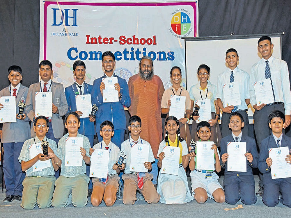 Winners of Inter school Quiz competition (Seniors, Standing from left) Samuel A and Tony Jaron J (First), Varshith Gowda M and Sudhee Shyam (Second), Anoushka Kondaskar, Sweekruthi Prabhakar (Third), Vishal Dubey and Vivek  Yadav (consolation). (Juniors, sitting, from left) Sai Kiran Tangirala and Dhruv G Nayak (First), Tanmay Gupta and Vayun Gupta (Second), Dakshinya Sriya M and Samrat S K (Third), Chitrith Y and Anirudh V (consolation), are seen with  Prof Arul Mani, English professor and Quiz master(centre),  organised by Deccan Herald Newspaper in Education (DHiE) at Bal Bhavan in the city on Wednesday. DH