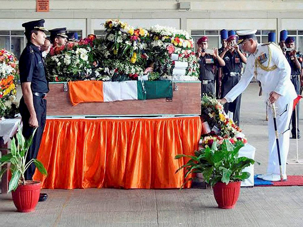 Vice Admiral K O Thakare paying his last respects to the mortal remains of Major Akshay Girish Kumar who was killed Nagrota camp attack, at Air Force Station in Bengaluru on Thursday. PTI Photo