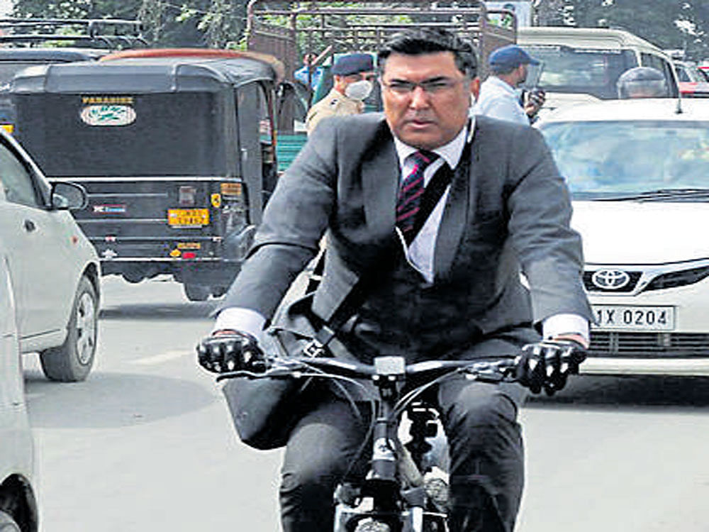 Dr Shafqat Khan, Health Officer of  Srinagar Municipal Corporation, rides  a bicycle in Srinagar. Umar Asif