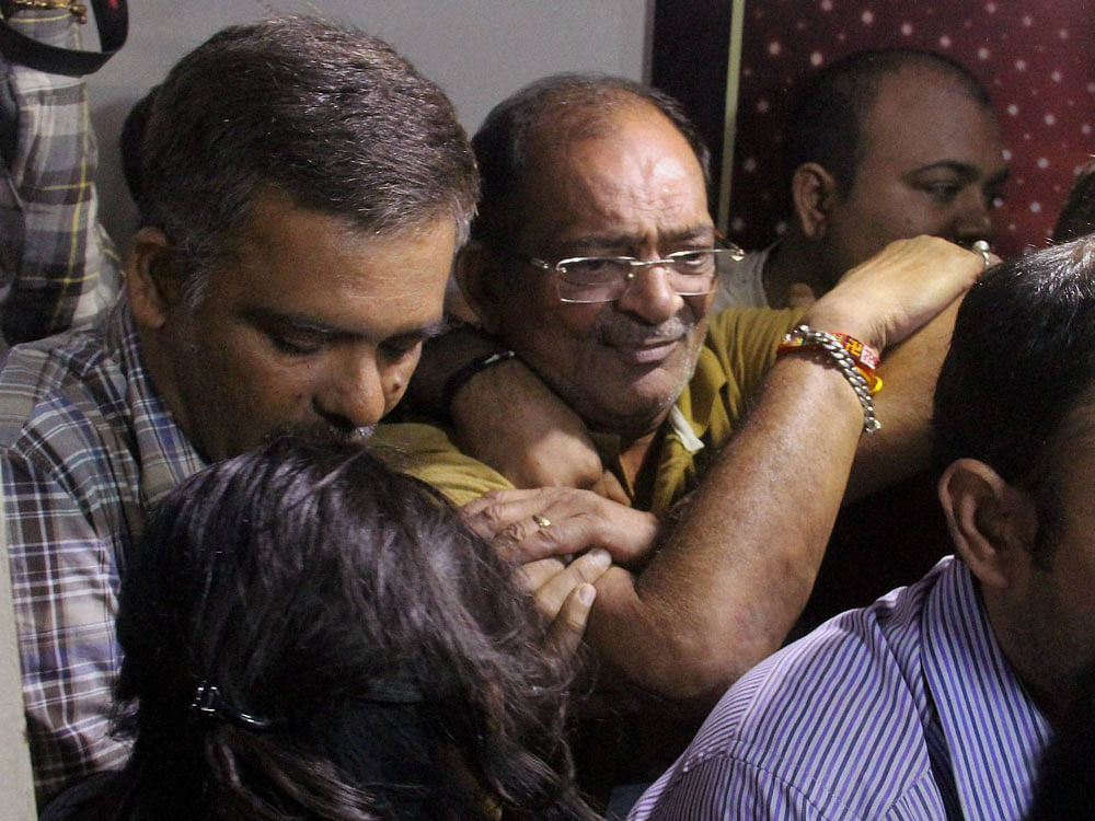 Police and Income Tax officials take land dealer Mahesh Shah into custody in Ahmedabad on Saturday. PTI