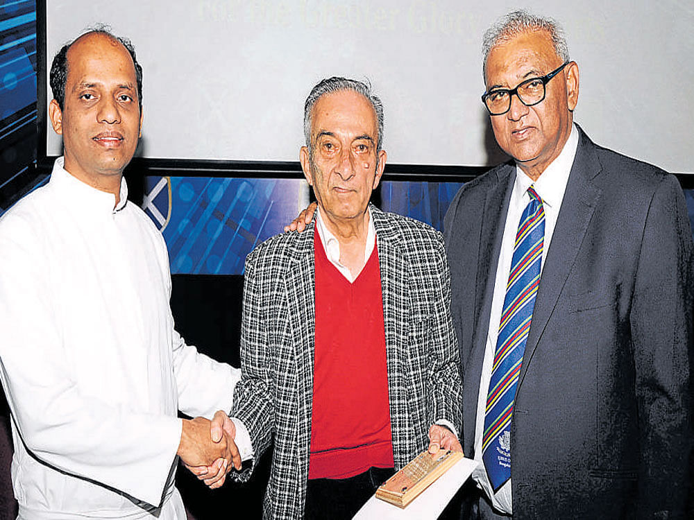 St Joseph's Boys' High School Principal Father Clifford  Sequeira greets sporting legends and old students of the school Tehmasp Moghul (centre) and A R Vece Paes at the first edition of 'Josephite Excellence in Sports' (Josexcel) awards ceremony in the city on Saturday. DH PHOTO