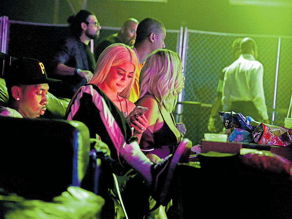Tyga and Kylie Jenner on their phones at the AlexanderWang 2017 party at Pier 94 in NewYork. INYT