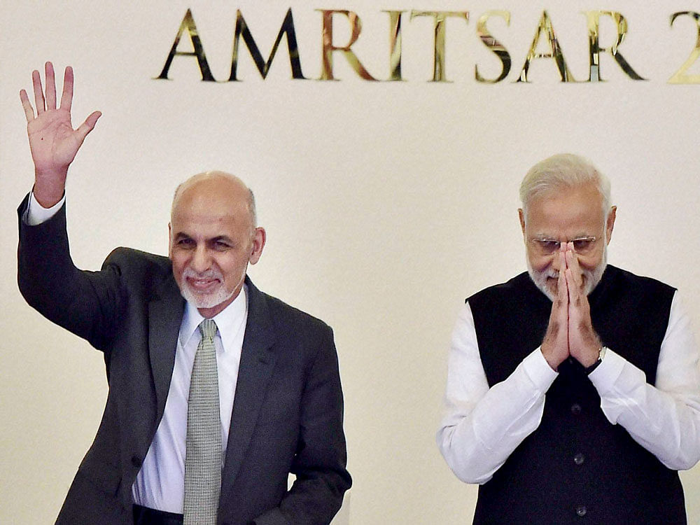 Prime Minister Narendra Modi and Afghan President Ashraf Ghani greet the delegates at the inauguration of the 6th Heart of Asia Conference in Amritsar on Sunday. PTI Photo