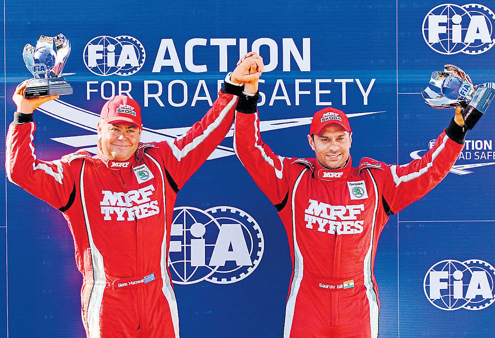 on a roll: India's Gaurav Gill (right) and co-driver Glenn Macneal hold aloft their spoils after winning the Coffee Day Rally.