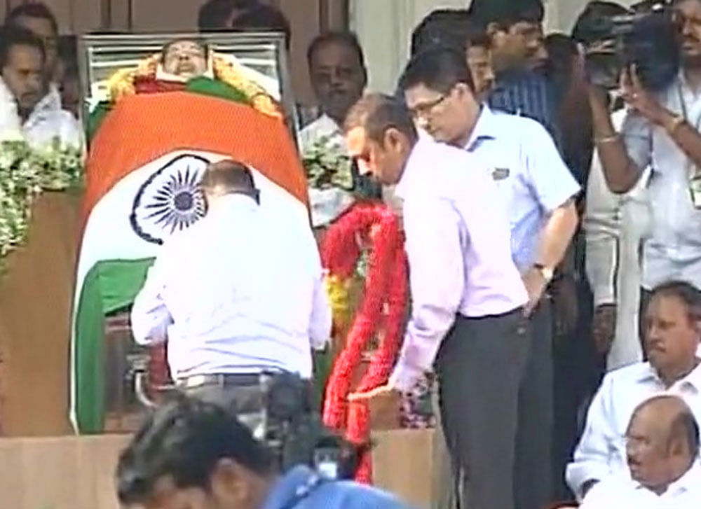 As the casket carrying the body of six-time chief minister was placed on the steps of Rajaji Hall, in the heart of the city off arterial Anna Salai, four Army men covered it with the national Tricolour.