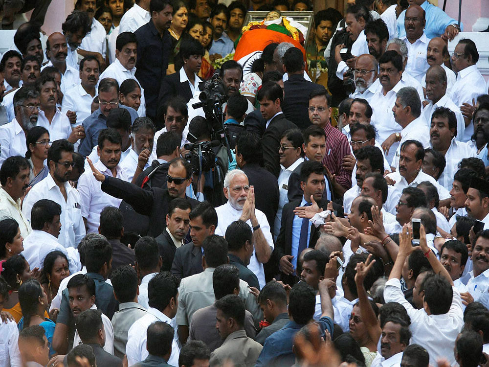 Prime Minister Narendra Modi greets supporters of Tamil Nadu's former Chief Minister Jayaram Jayalalithaa, after paying his last respects to her at Rajaji Hall in Chennai on Tuesday. PTI Photo