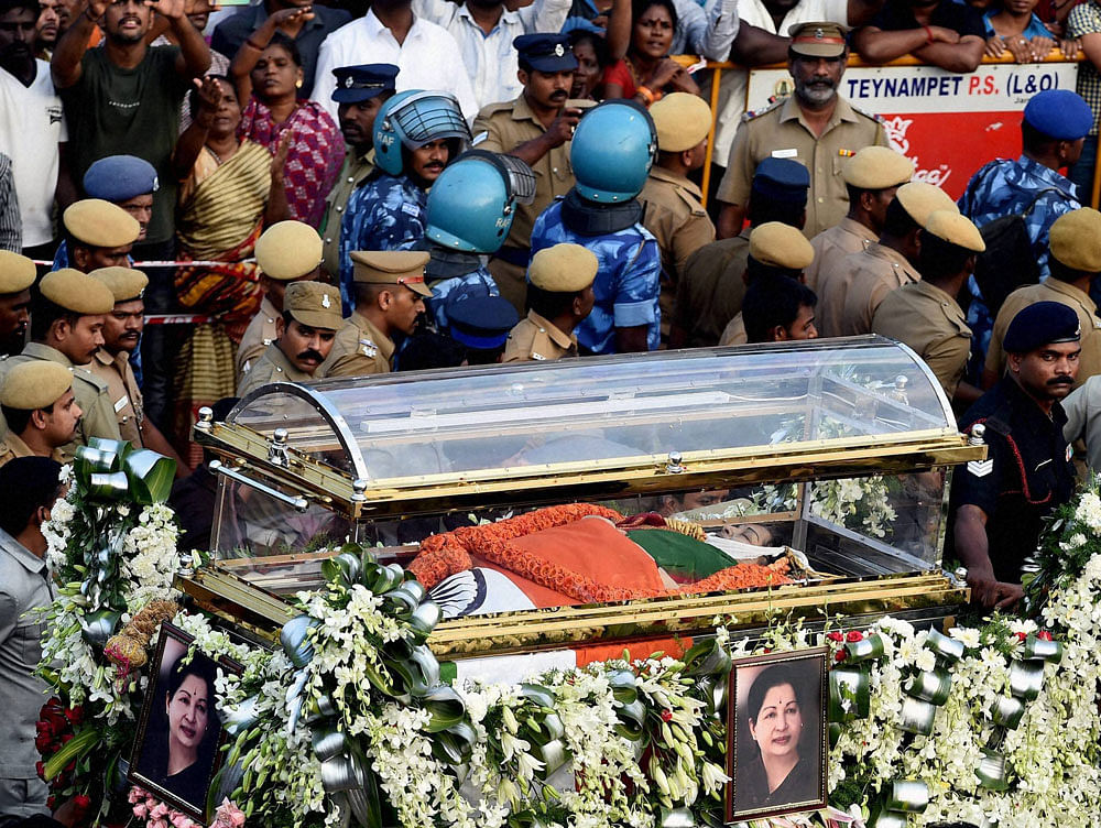 Security personnel carrying the Tamil Nadu's former Chief Minister J Jayalalithaa's mortal remains during her funeral procession in Chennai on Tuesday. PTI Photo