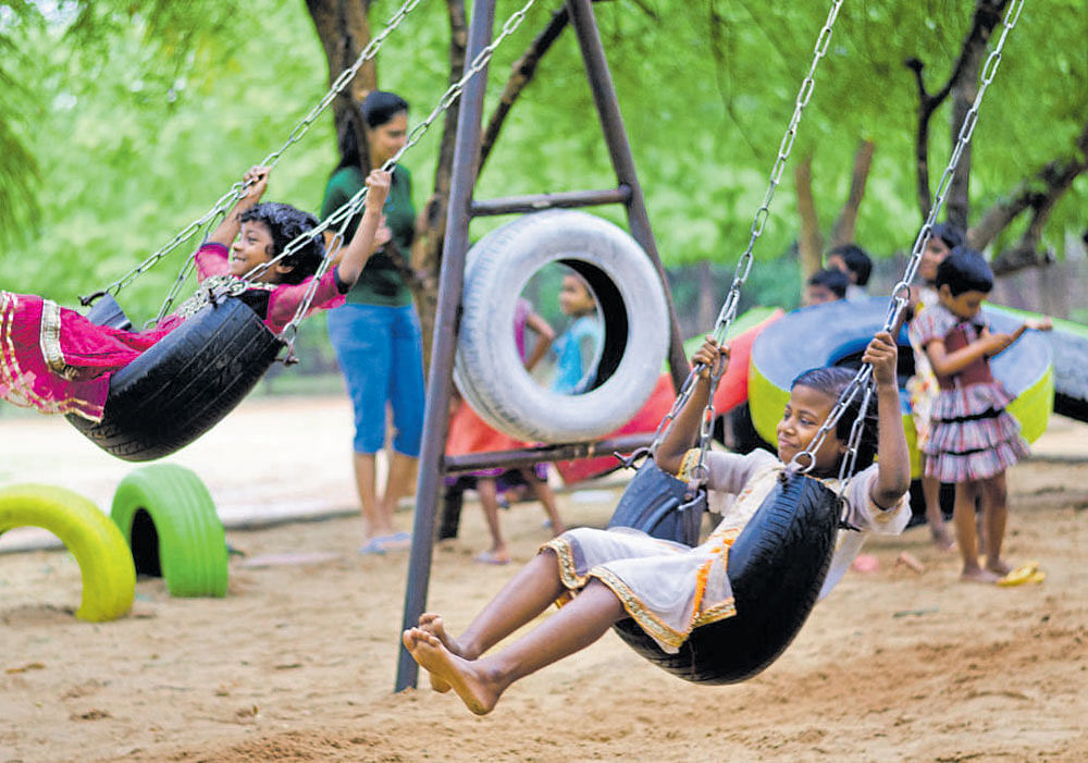 CHEERFUL BUNCH Upcycled tyres used to create swings and other playground equipment.