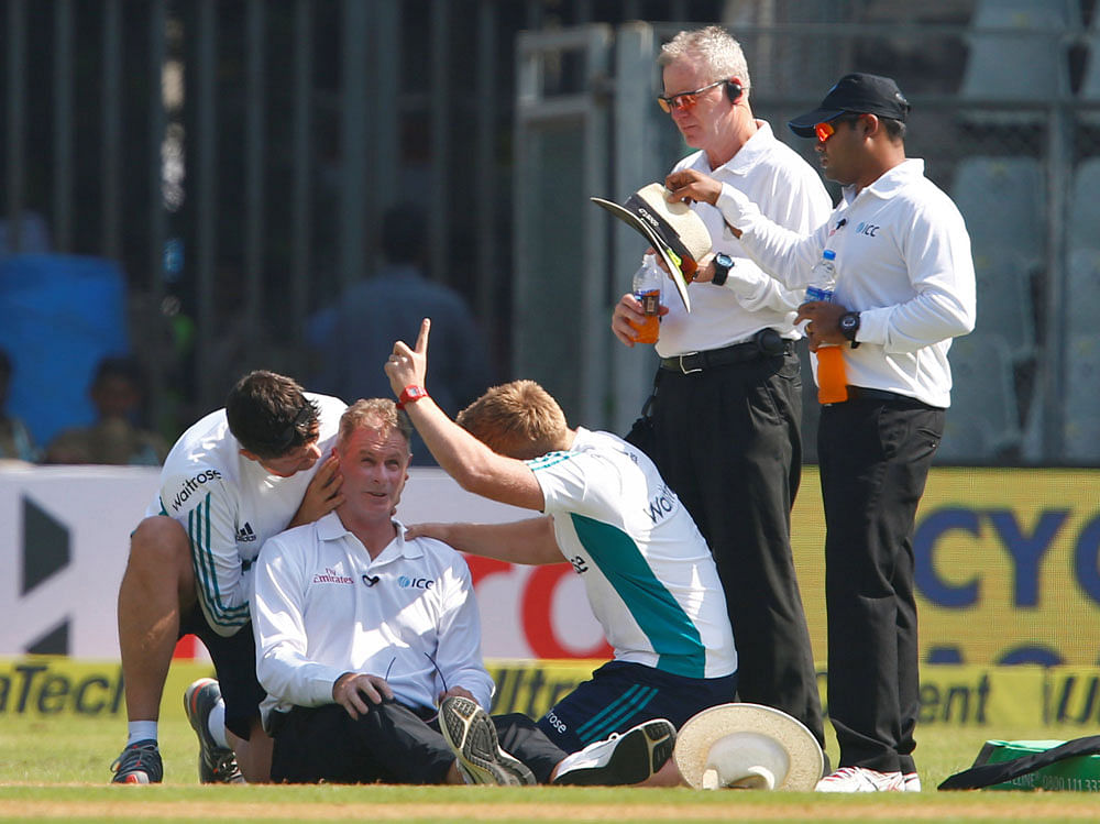 Ouch! Umpire Paul Reiffel collapses after being hit by a throw from Bhuvneshwar Kumar. Reuters