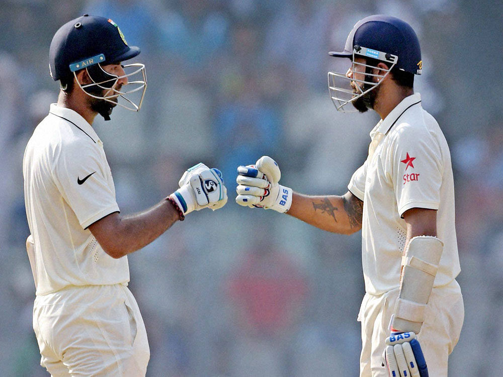 Indian batsmen Cheteshwar Pujara and Murli Vijay during the 2nd day of the 4th test match against England in Mumbai on Friday. PTI Photo
